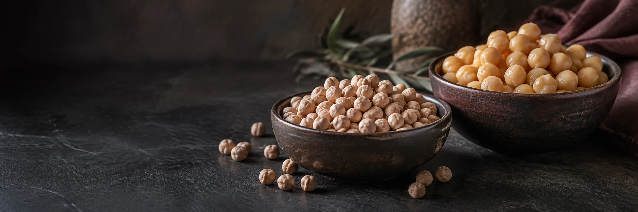 Bowls of dry chickpeas and plain cooked chickpeas illustrating chickpeas ingredient context.