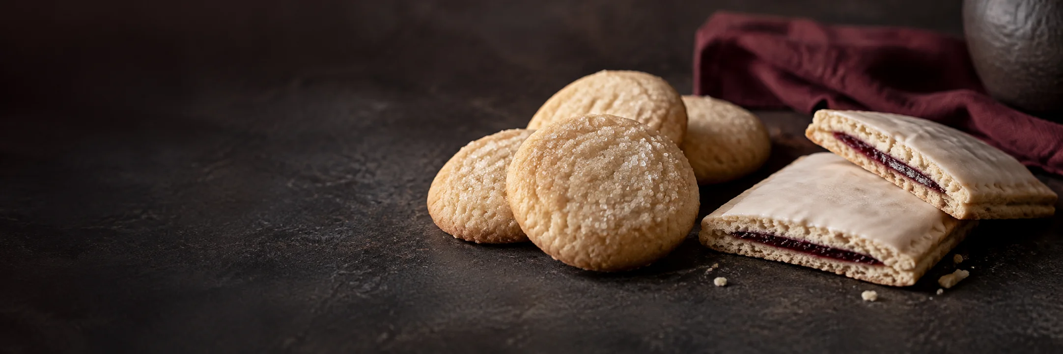 Plain round sugar cookies and a cut rectangular iced toaster pastry illustrating toaster pastry ingredient context.